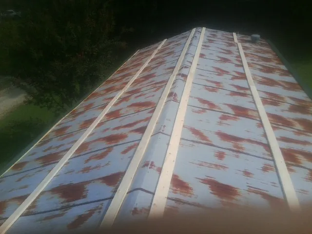 Rusted metal roof panels with new wood purlins before replacement — Storm Damage Roof Repair in Cockeysville by Roofing Brothers
