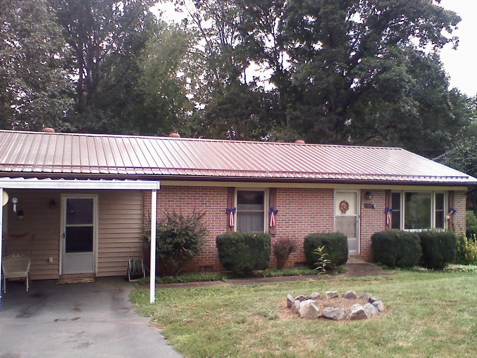 Bronze metal roof and carport on a brick ranch home — Roof Repair work by our crew in Cockeysville